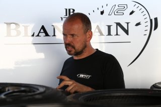 CREW MEMBER WORKING ON PIRELLI TYRES
