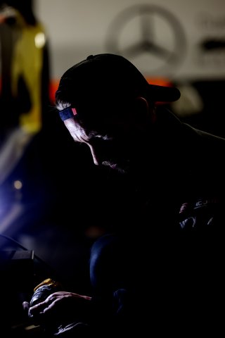 Mechanics at work in the pit lane
