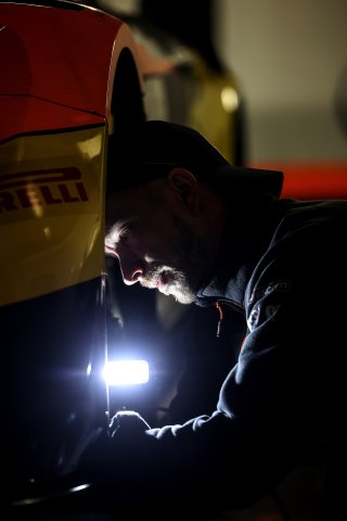 Mechanics at work in the pit lane
