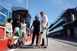 Drivers discussing in the pitlane
