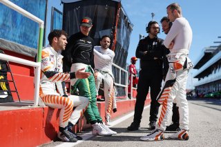 Drivers discussing in the pitlane
