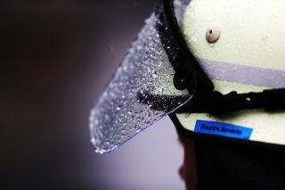 Rain on the visor of a pitlane marshal