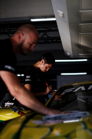 Mechanics at work in the pit lane