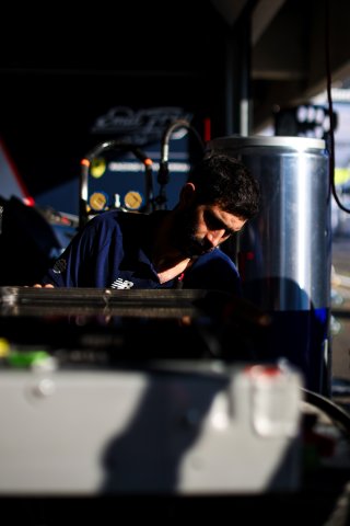 Mechanics at work in the pit lane