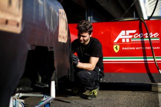 Mechanics at work in the pit lane