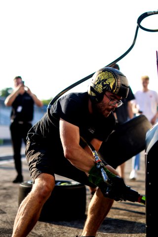 Mechanics at work in the pit lane