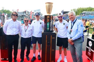 The winners trophy is delivered to the grid by the 2025 Champions 
