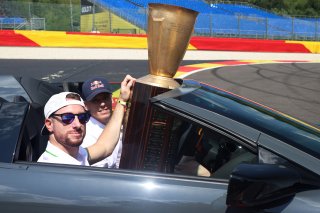 The winners trophy is delivered to the grid by the 2025 Champions